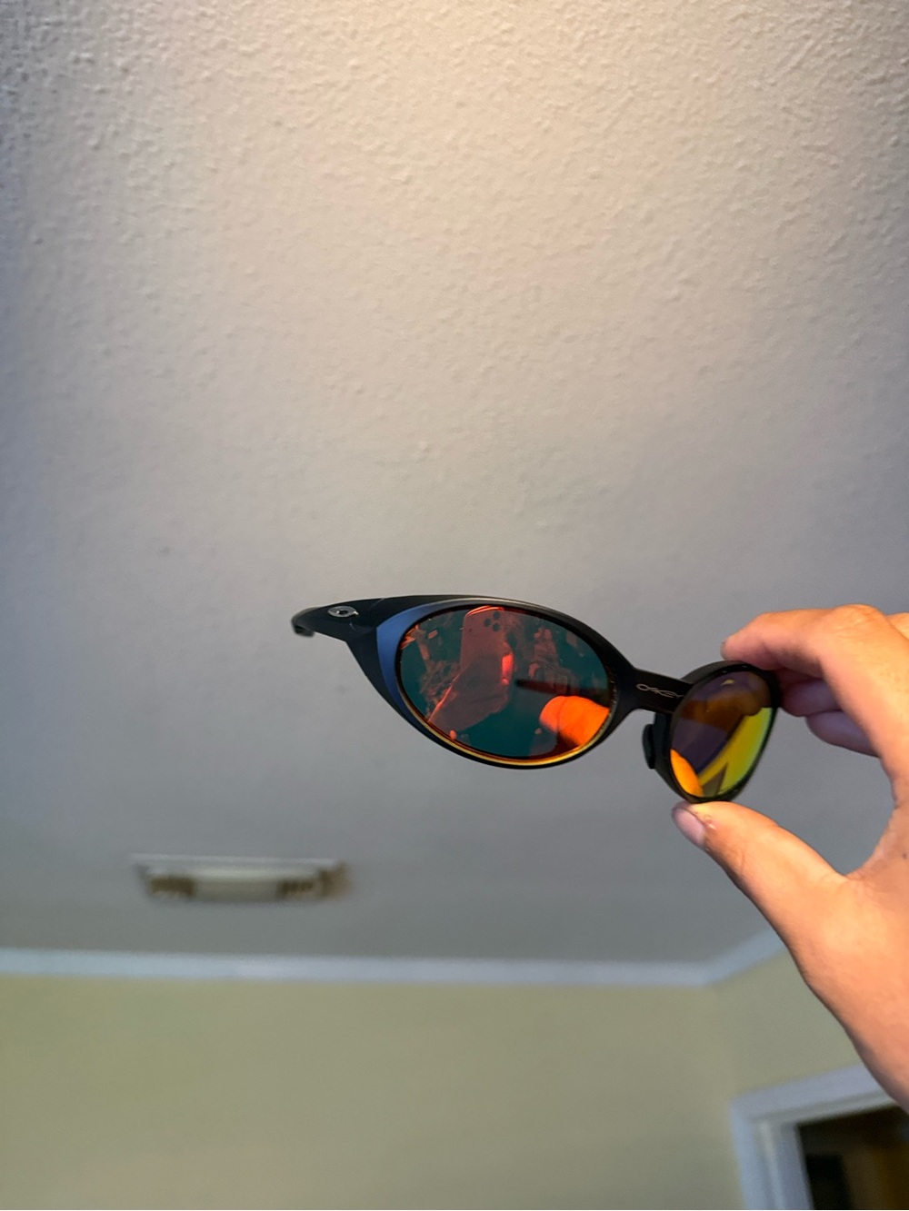 Black Oval Sunglasses with Red-Orange Mirrored Lenses Oakleys